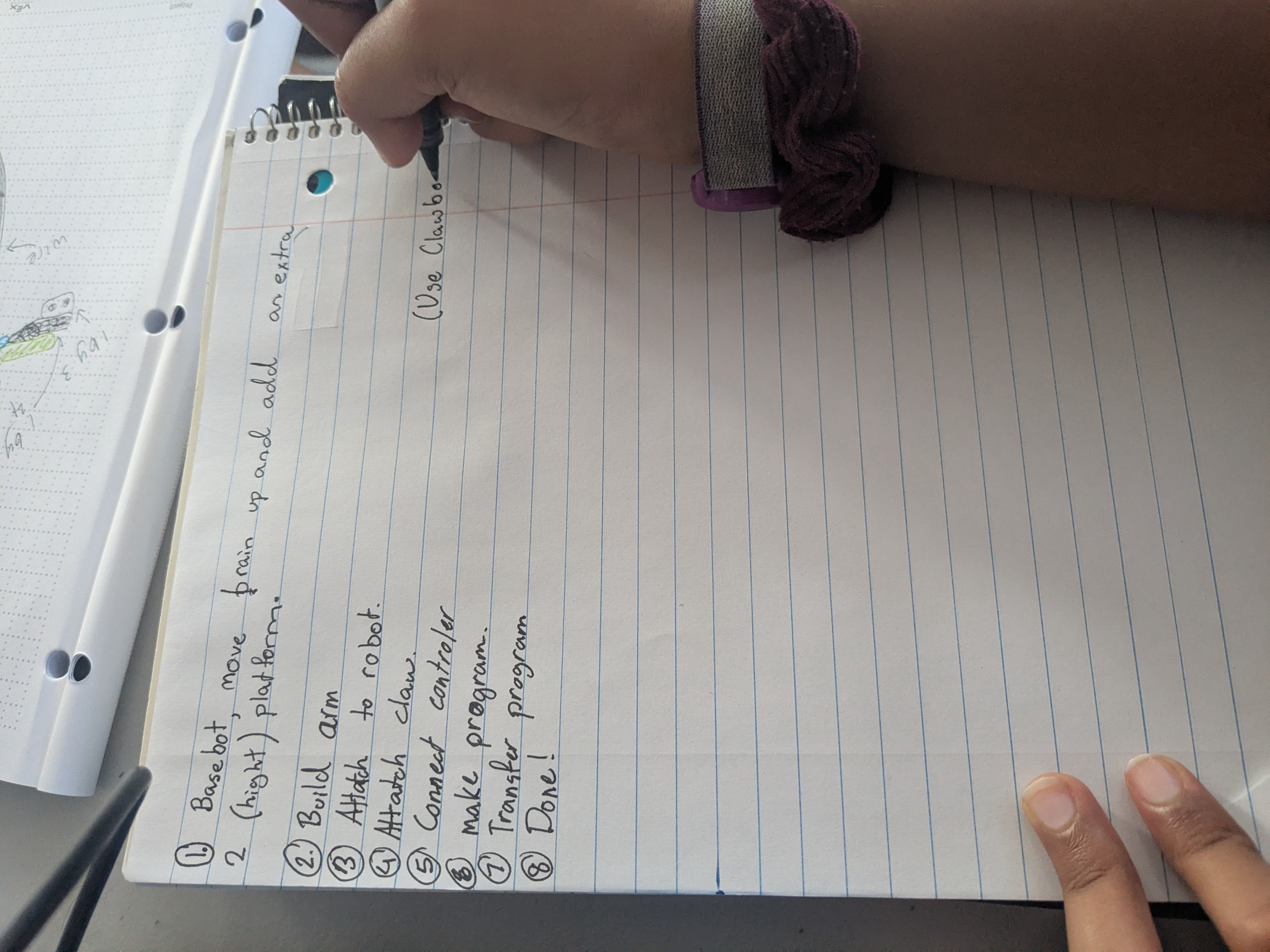 Students writing in engineering notebooks